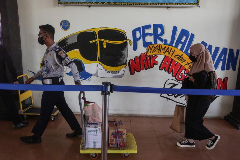 Seorang petugas membantu mendorong troli barang bawaan pemudik menuju area kedatangan bus Antar Kota Antar Provinsi (AKAP) di Terminal WA Gara, Palangka Raya, Kalimantan Tengah, Sabtu (23/4/2022). Sejumlah warga memilih mudik lebih awal ke sejumlah kota tujuan di daerah Kalimantan untuk menghindari harga tiket tinggi dan kepadatan penumpang saat puncak arus mudik mendatang.