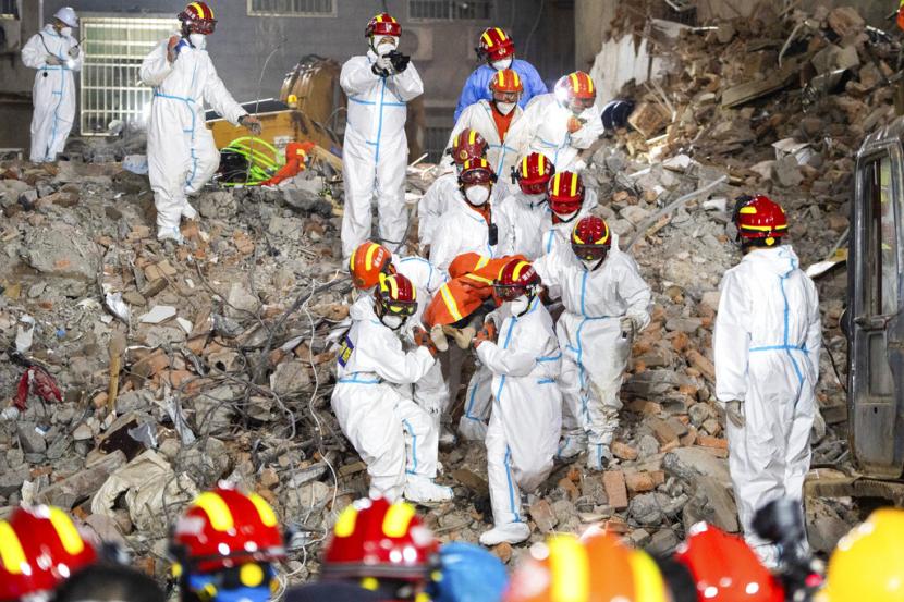 Dalam foto yang dirilis oleh Kantor Berita Xinhua, petugas penyelamat mengevakuasi korban selamat ke-10 yang berhasil diselamatkan setelah terperangkap 132 jam dari puing-puing bangunan perumahan yang dibangun sendiri yang runtuh di Changsha di Provinsi Hunan, China tengah pada Kamis 5 Mei 2022. Pihak berwenang mengatakan Jumat pencarian telah berakhir untuk orang-orang yang terperangkap dari keruntuhan.