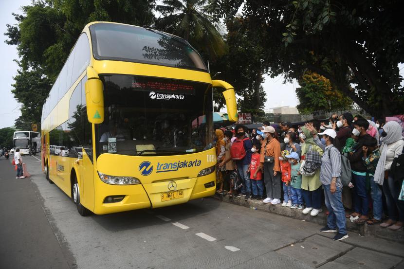 Warga antre untuk masuk ke dalam bus wisata gratis Transjakarta di Jakarta, Rabu (4/5/2022). PT Transportasi Jakarta (Transjakarta) mengoperasikan bus wisata gratis selama libur Lebaran yang beroperasi mulai pukul 10.00 hingga 21.00 WIB.
